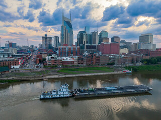 Barge on the Cumberland River and downtown Nashville, Tennessee, United States.