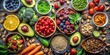 © PloyJai - Flat lay of healthy vegetarian meal ingredients including organic fruits, nuts, berries, vegetables, and avocado, vegetarian
