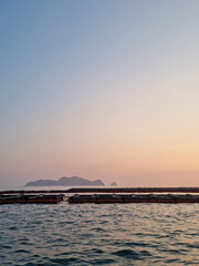 Wall Mural - This is the sunset over the sea where the fish farm is located.