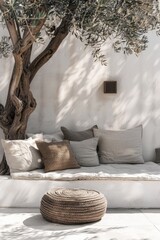 Aufkleber - A white couch sitting under a tree next to a white wall, perfect for outdoor or interior design inspiration