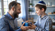 © NewFresh  - happy father and son with gift box at christmas or birthday party