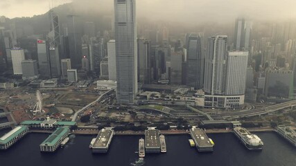 cbd, buildings and drone of infrastructure in the city in hong kong with grey cloudy sky. cityscape,