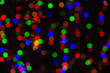 © katelynn - red, blue, green, and orange blurred out Christmas lights with a black background