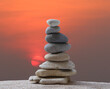© meepoohyaphoto - Stacked stones in a pyramid shape on a background on sunrise.