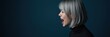 © Makaron - A side profile of a young woman with short, silver hair, passionately expressing herself against a dark blue background, perfect for themes of communication and emotion.