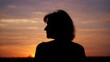 © lovelyday - Silhouette of lonely woman standing alone seeing sunset sunrise on evening beach, in loneliness with emotional feeling, or peaceful with solitude,on copy space for text sky background