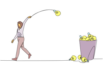 Poster - single one line drawing businesswoman walking throwing lightbulb into trash can. throwing away the o