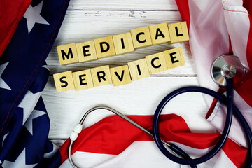 Medical Service alphabet letters with USA flag on wooden background