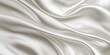 © Palugada - Closeup of rippled white satin fabric texture background. Luxurious background design