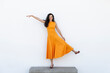 © VISTA by Westend61 - Beautiful woman standing on one leg over bench near wall