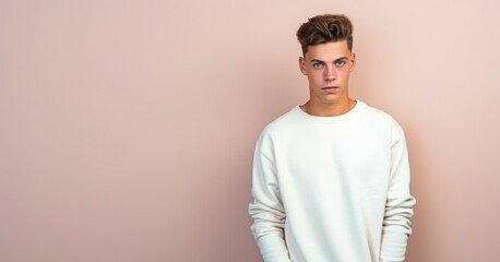 Canvas Print - A young man is wearing a white shirt and standing in front of a white wall