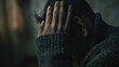 © VK Studio - A person with hands on their head, bathed in dim light, evokes a sense of stress and contemplation, highlighting emotional depth.