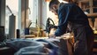 © VK Studio - A focused craftsman works intently with a sewing machine by a bright window, embodying dedication and skilled craftsmanship.