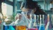 © VK Studio - An inquisitive young scientist in safety goggles conducts an experiment in a lab, surrounded by colorful test tubes.