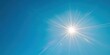 © soem - A bright sun shining in a clear blue sky with soft lens flare and no clouds.