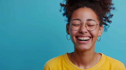 Poster - A woman with curly hair is smiling and wearing glasses