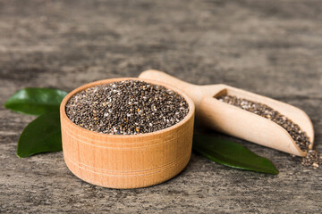 Wall Mural - Chia seeds in bowl and spoon on colored background. Healthy Salvia hispanica in small bowl. Healthy superfood