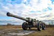 © Kitta - Unveiling a World War II Artillery Piece: A Glorious Remnant of Military History Against a Dramatic Sky