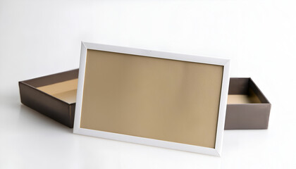 Unframed beige display resting on a white background next to a brown box, showcasing an empty space for art or photos