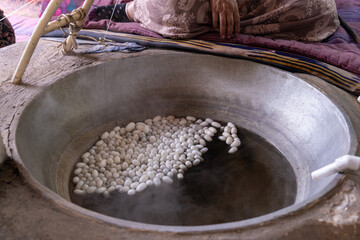 A large bowl filled with white objects is sitting on a stove