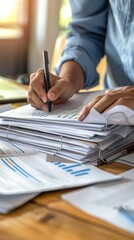 a person examining a stack of financial documents and reports, emphasizing financial management and 