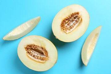 Poster - Fresh cut melon on light blue background, flat lay