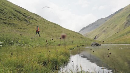 Poster - Fit sporty healthy woman trekking in summer majestic mountains alone solo enjoy weekend trip. Active woman hiker enjoys the beautiful scenery of the majestic mountains. Travel, adventure