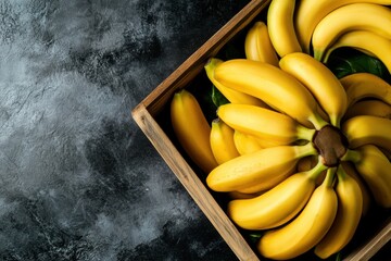 Wall Mural - Fresh bananas in wooden crate on dark background