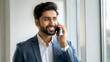 © N7 - Indian Professional Making a Call - An Indian male office worker in business casual attire talking on a mobile phone.