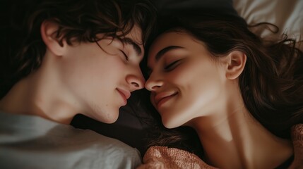 Wall Mural - A young couple sharing an intimate moment while lying close together in a cozy bedroom at dusk, enjoying their time together