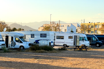 caravan park. campervan in camp parking at coastline. family camper van vehicle at seaside. rving mo