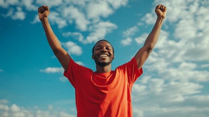 Poster - A man in a red shirt is smiling and raising his hands in the air