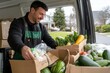© woters - Man organizing fresh vegetables in a delivery van on a sunny day in a suburban neighborhood