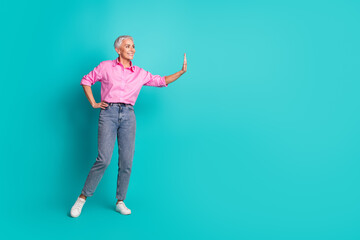 Sticker - Full body portrait of nice aged lady arm push touch empty space wear shirt isolated on turquoise color background