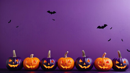 Colorful jack-o'-lantern pumpkins row against purple background with bats