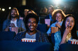 © Marko Geber - Diverse group of friends enjoying a movie together in a cinema