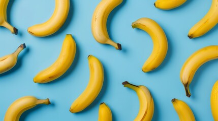 Poster - Bright yellow bananas scattered on a light blue background