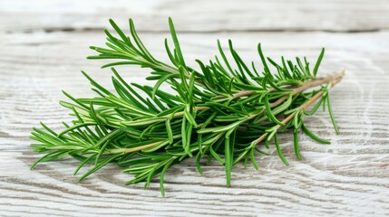 Poster - Fresh rosemary with visible texture and vibrant green color laid on a light wooden background