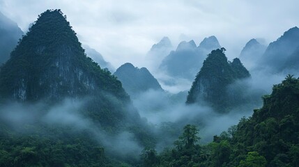 Majestic Southeast Asian mountain range with mist-covered peaks, serene landscape, no people