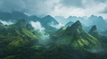 Stunning Southeast Asian mountain range with mist-covered peaks, lush valleys below, no people