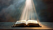 © W - A book is open to a page with a sun shining on it. The sun is casting a warm glow on the pages of the book