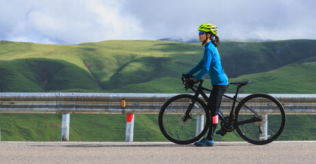 Poster - Woman cyclist with road bike ready to hit the road