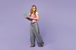 © ViDi Studio - Full body young IT employee business woman corporate lawyer she wears classic suit vest white t-shirt glasses work in office hold use laptop pc computer look aside isolated on plain purple background.