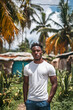 © Agata25 - Handsome Haitian man standing confidently in lush outdoor setting