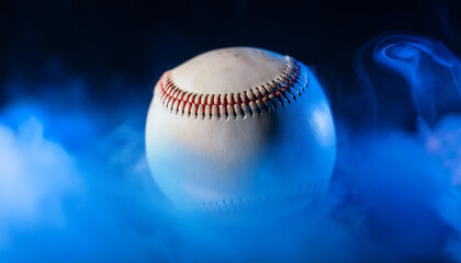 Baseball ball in blue smoke on dark backdrop. Sport game concept. Close-up.