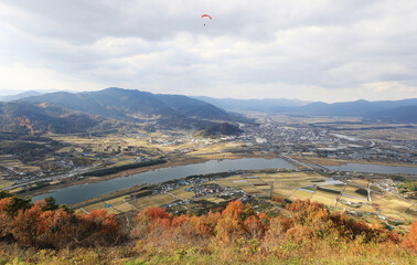 Wall Mural - Gurye-gun, Jeollanam-do, South Korea - November 13, 2021: Autumal and aerial view of Seomjingang River with rice fields and houses