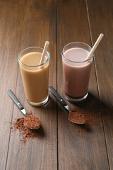 Poster - Delicious protein shakes in glasses and spoons with powder on wooden table