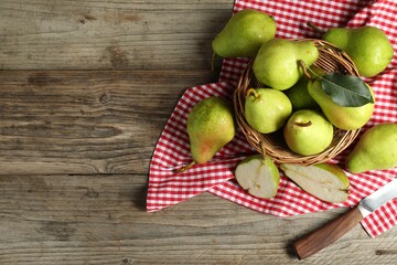 Wall Mural - Fresh green pears and knife on wooden table, flat lay. Space for text