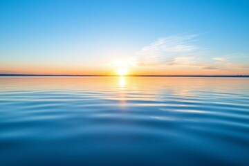 Poster - Stunning sunrise on the lake. The sun's rays through the fog. Blue skies above the lake. Morning comes, the sky is reflected.
