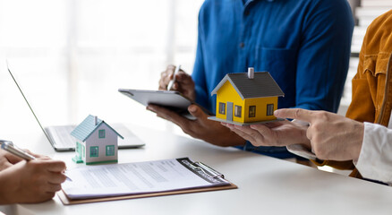 Wall Mural - Businessman and real estate agents discussing documents signing a legal purchase of a house.